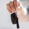 leasing or buying car shown by hand with car keys